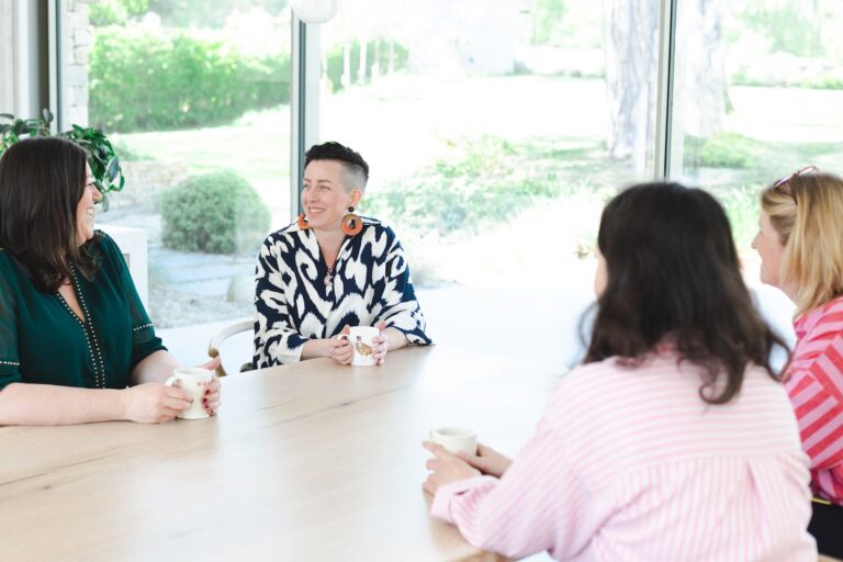 Rowenna running a therapy workshop with a group of women round kitchen table, London hypnotherapist