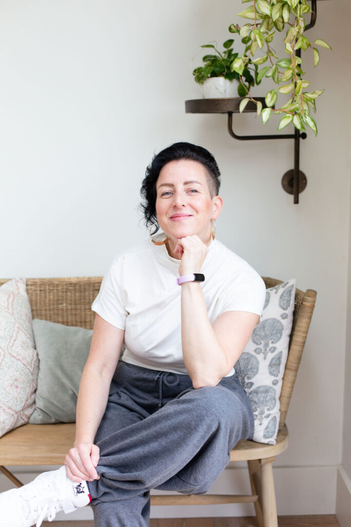 Image of Rowenna sitting on a bench under a plant, NLP Coaching and therapist coaching online