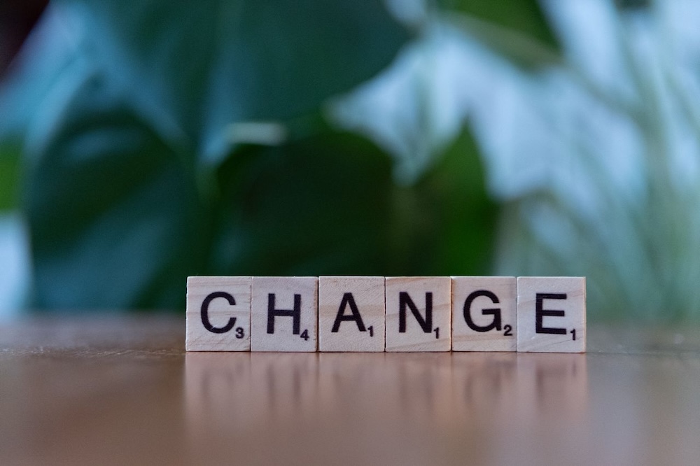 Image of a set of scrabble tiles that spell the word change