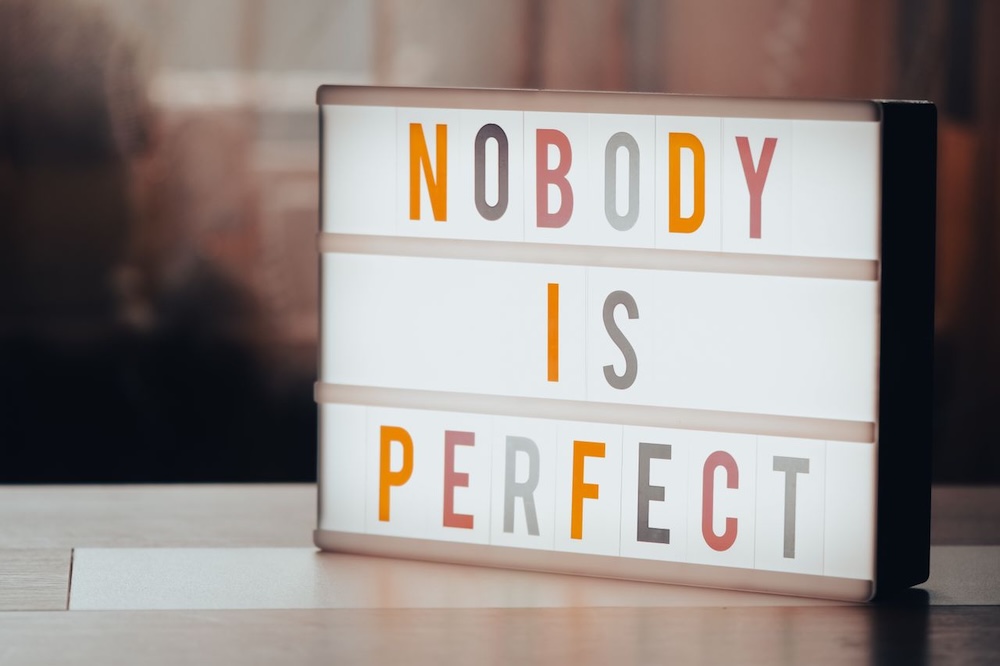 Image of a letter board with the words nobody is perfect on it, how to overcome perfectionism blog
